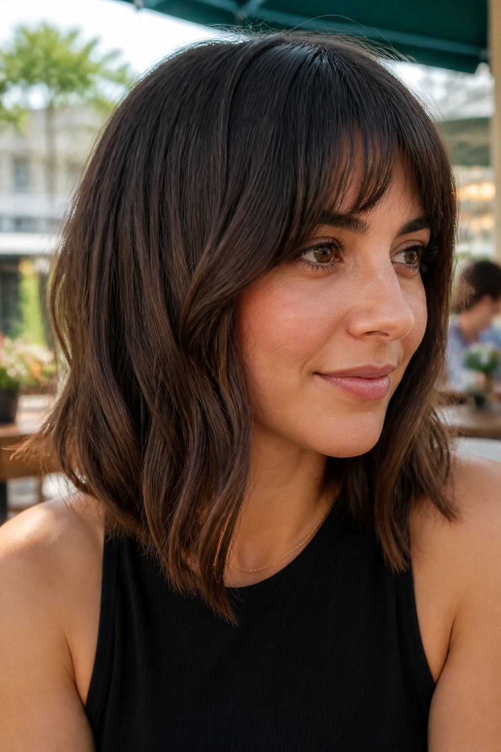 Portrait of a woman with A-line lob and longer corner bangs