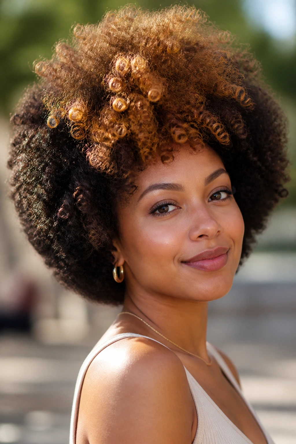 Real woman with rounded Afro and caramel coils at the crown