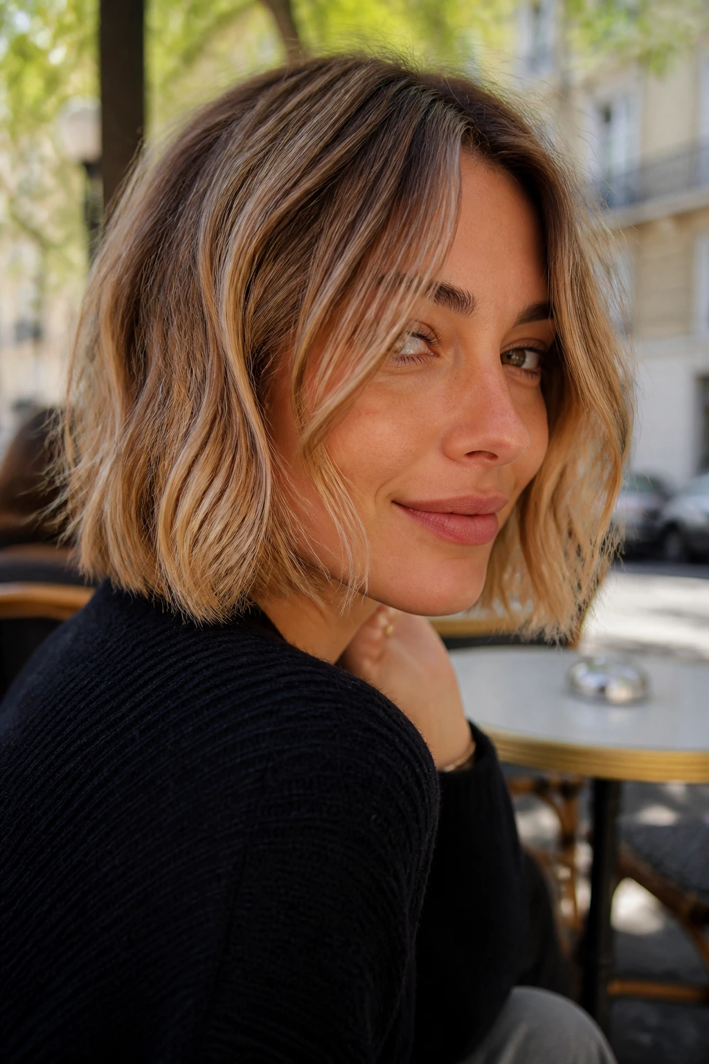 Real woman with a natural air-dried French-girl bob in morning light.