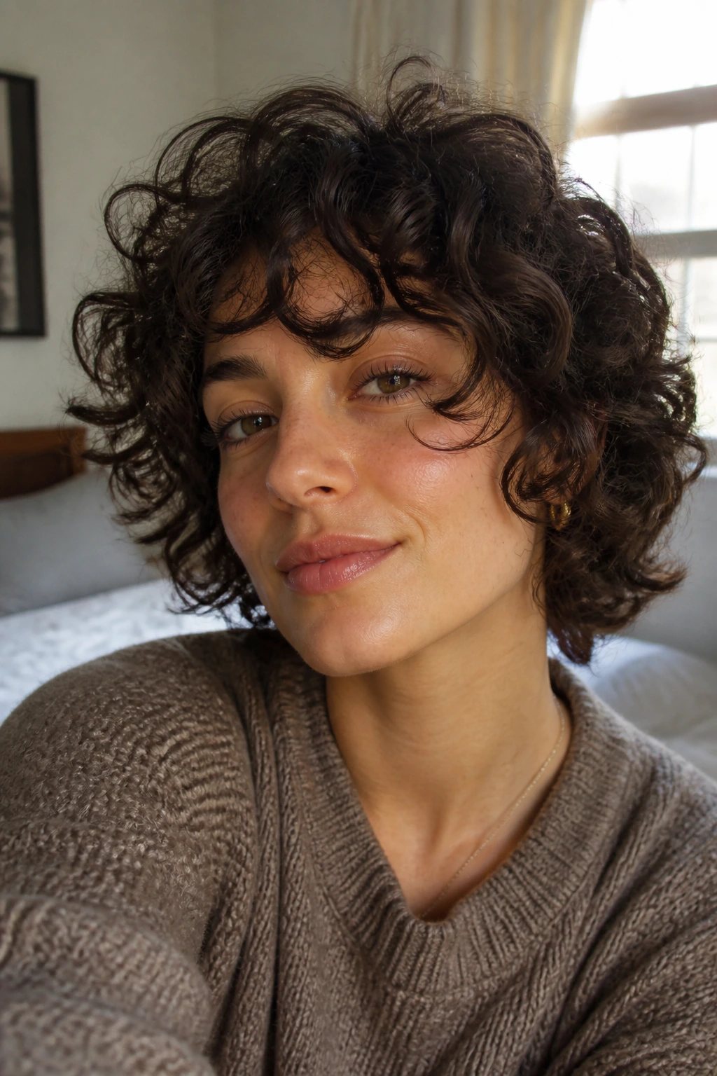Close-up of a real person with airy cuts for thick curls in warm natural light