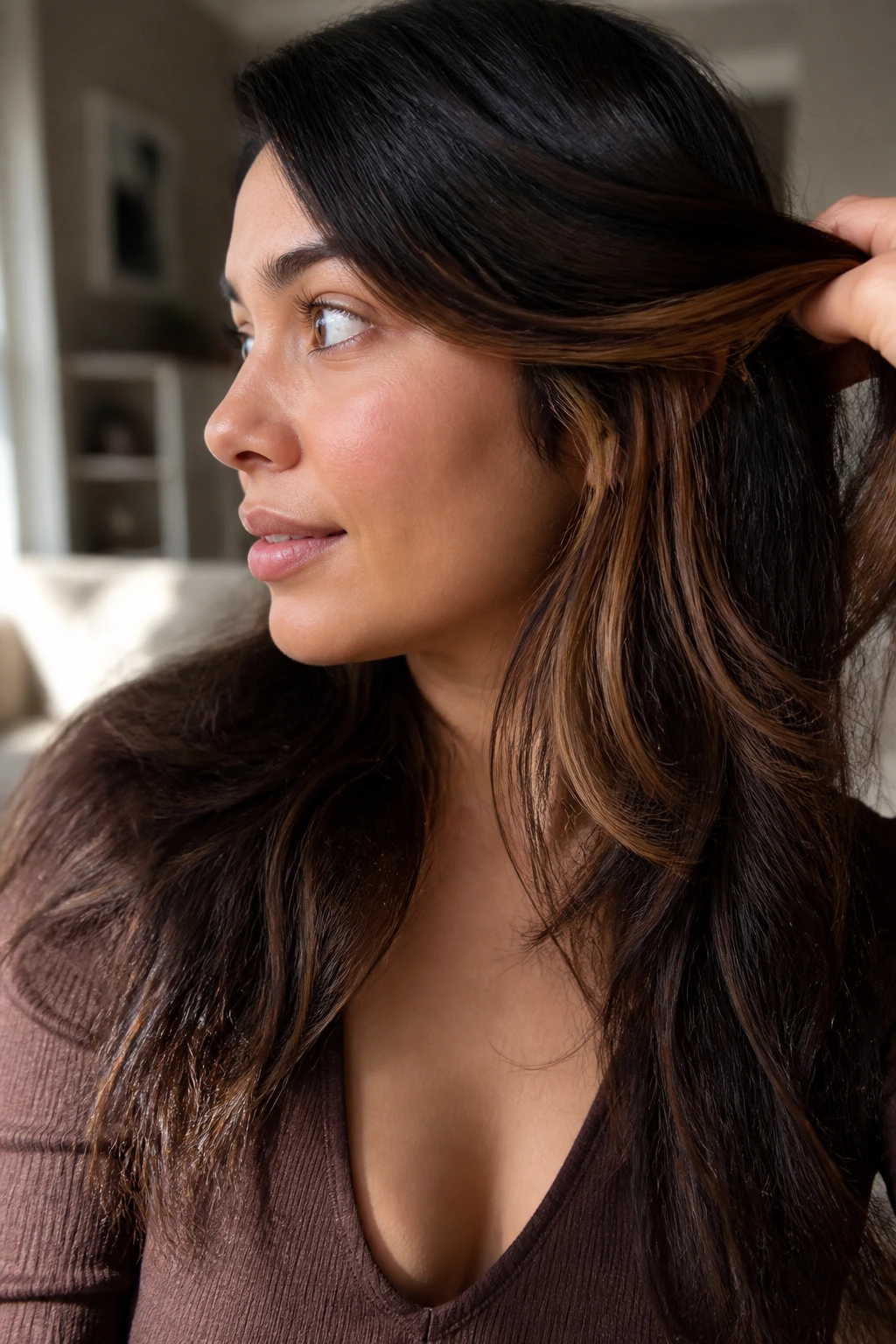 Close-up of amber brown peekaboo pieces under the hair on a real woman