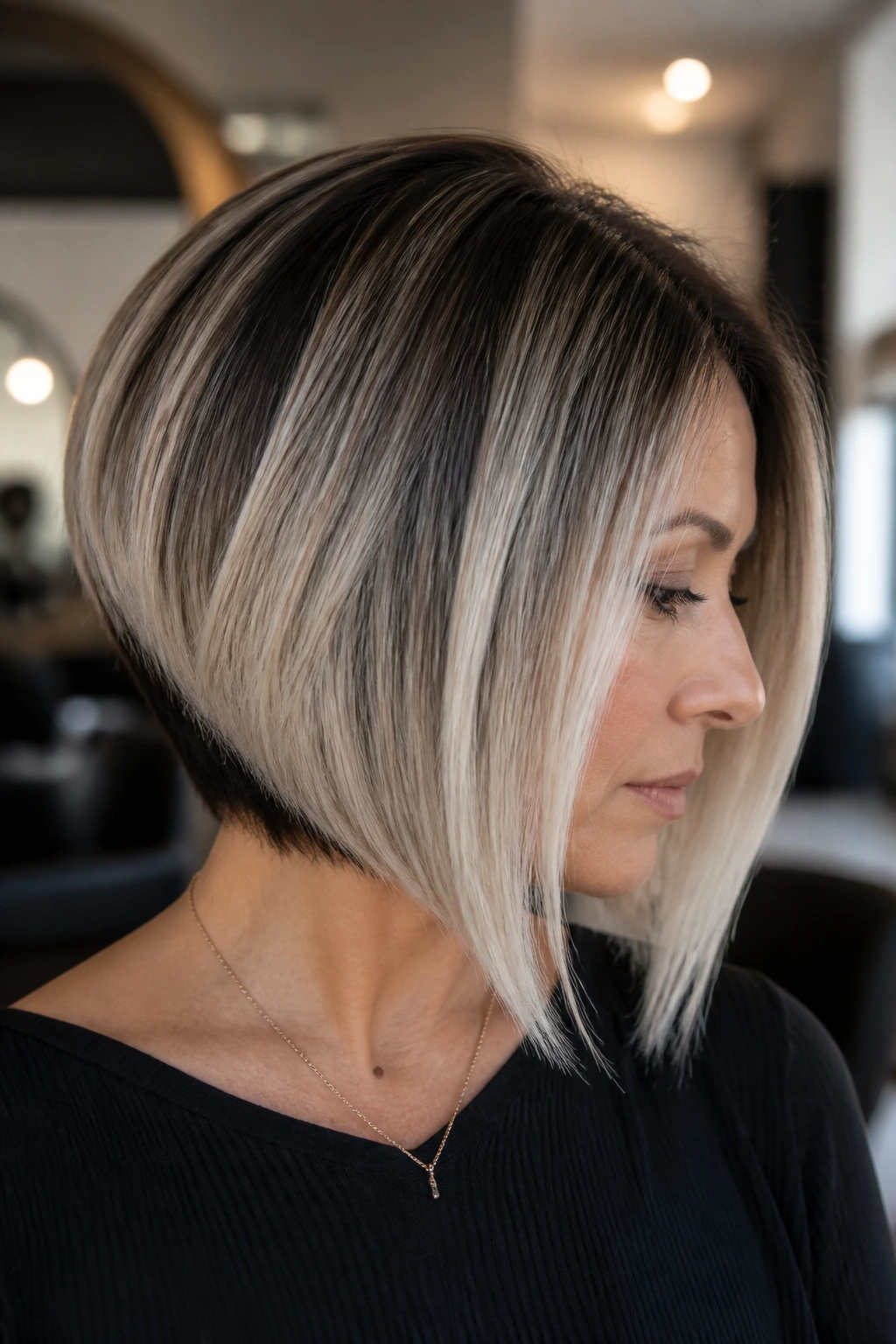 Close-up of angled bob with frosted perimeter on a real person in a salon