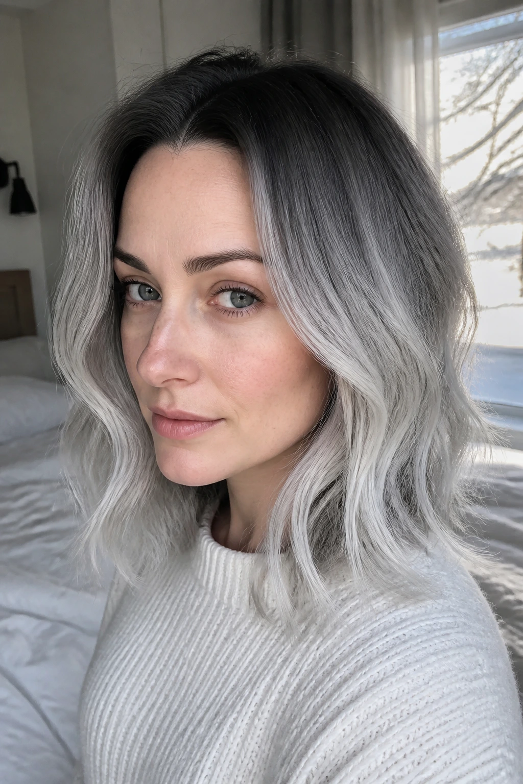 Close up of a real person with shoulder-length hair and frosted ends, root shadow visible
