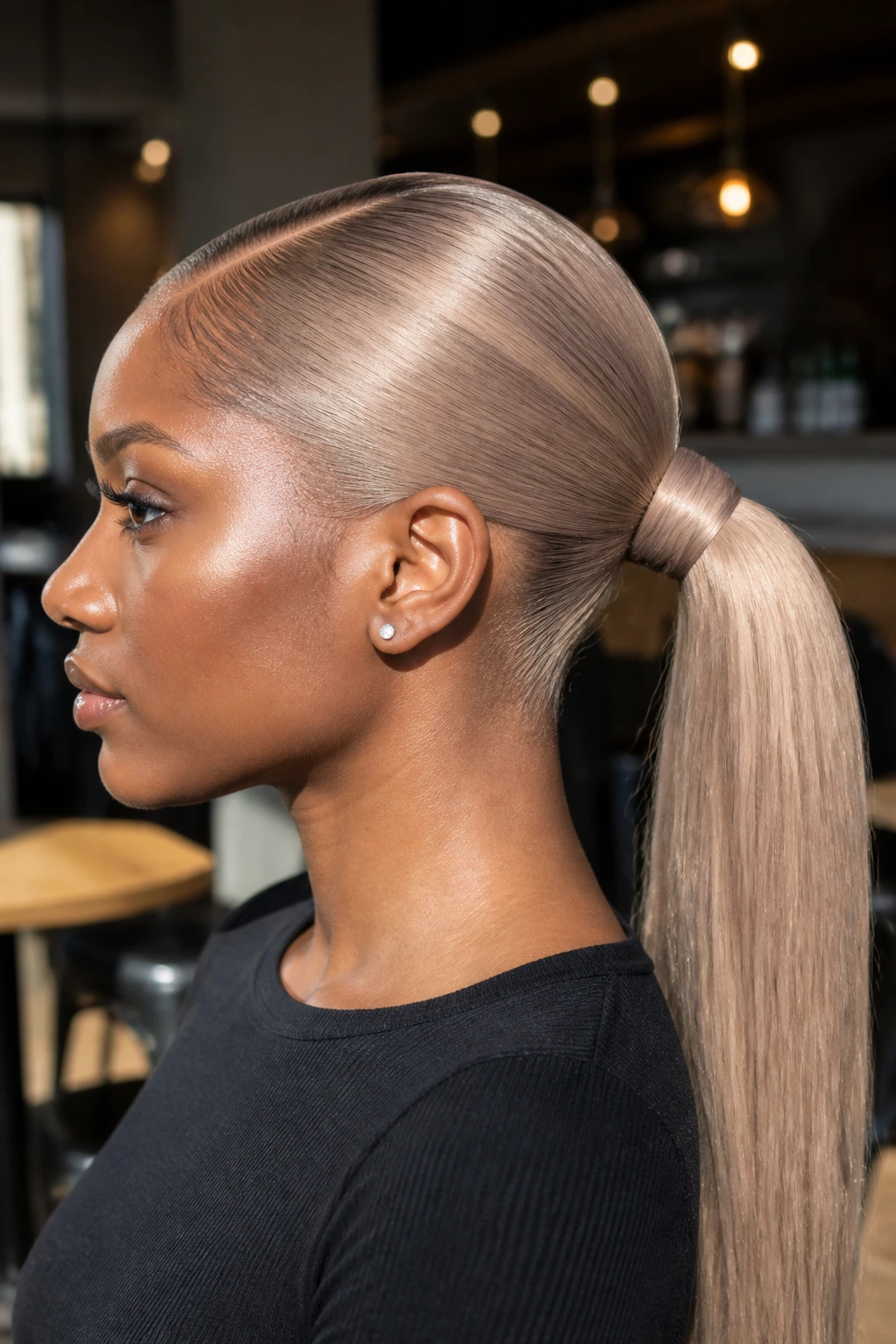 Portrait of a real woman with an ash-beige blonde sleek ponytail.