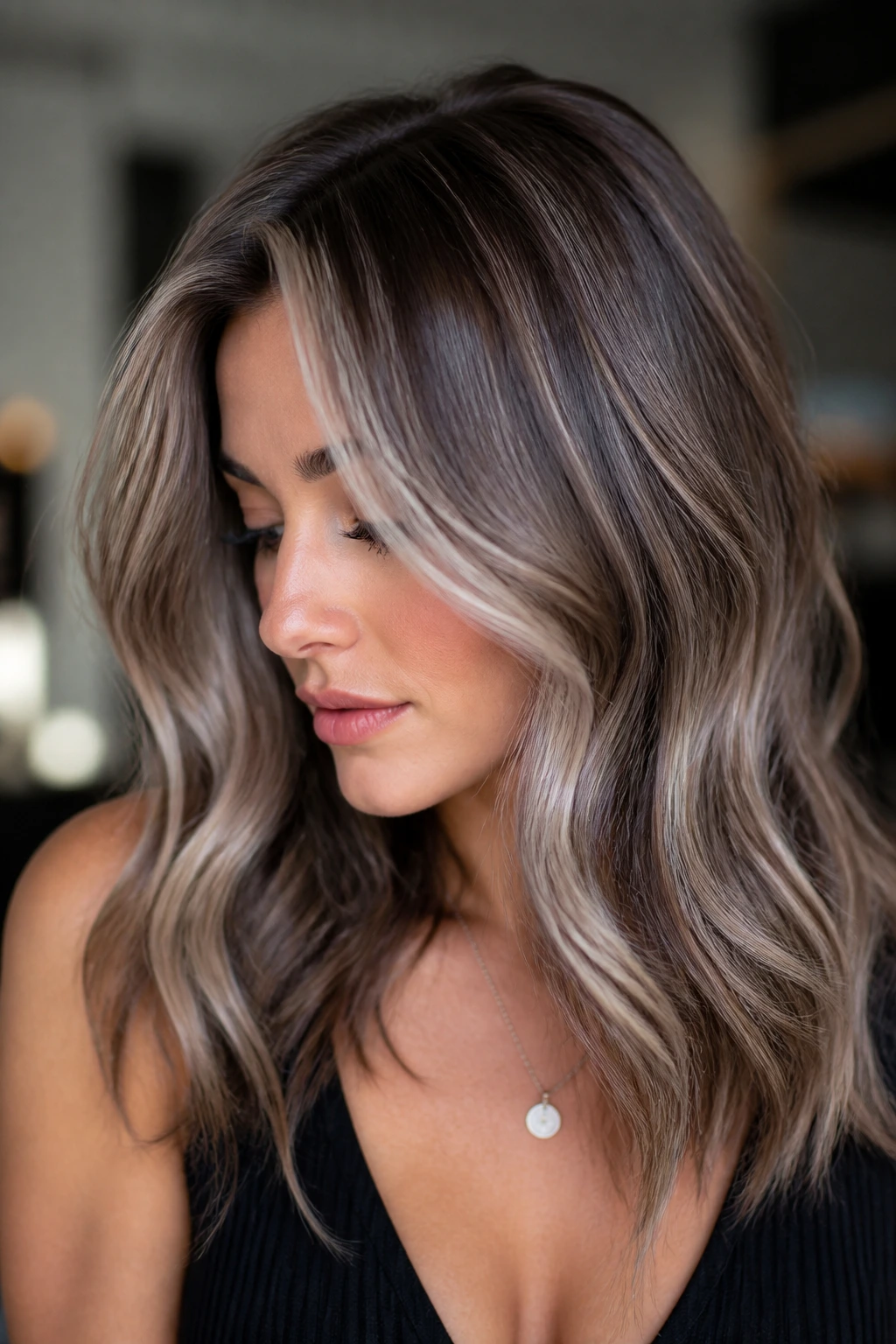Close-up portrait of a real woman with ash beige highlights on brunette base