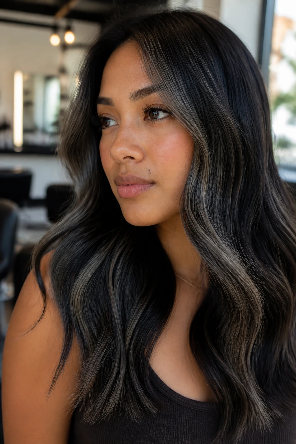 Close-up portrait of a real person with ash-black highlights flattering warm skin tones
