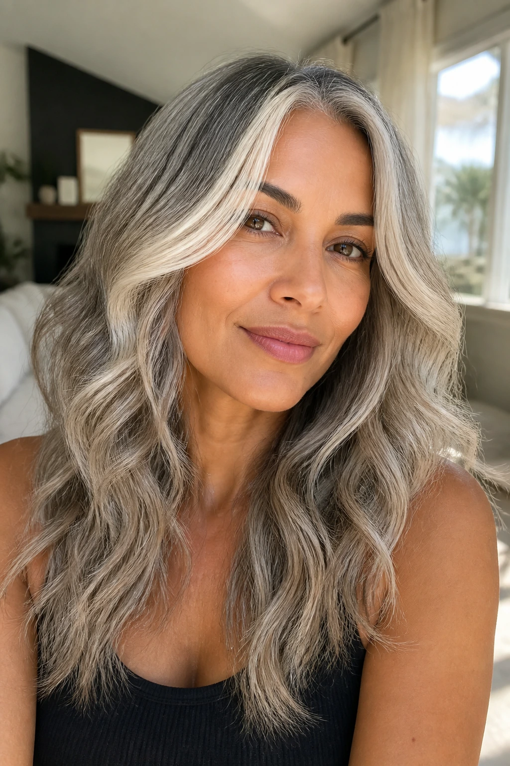 Portrait of a woman with ash blonde gray blend hair and waves