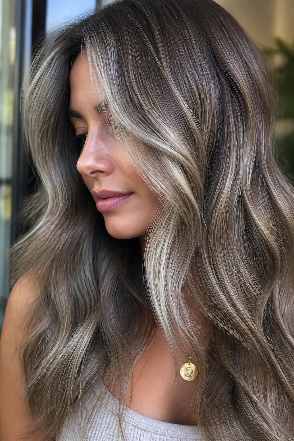 Brunette with melted ash blonde and silver babylights close-up.