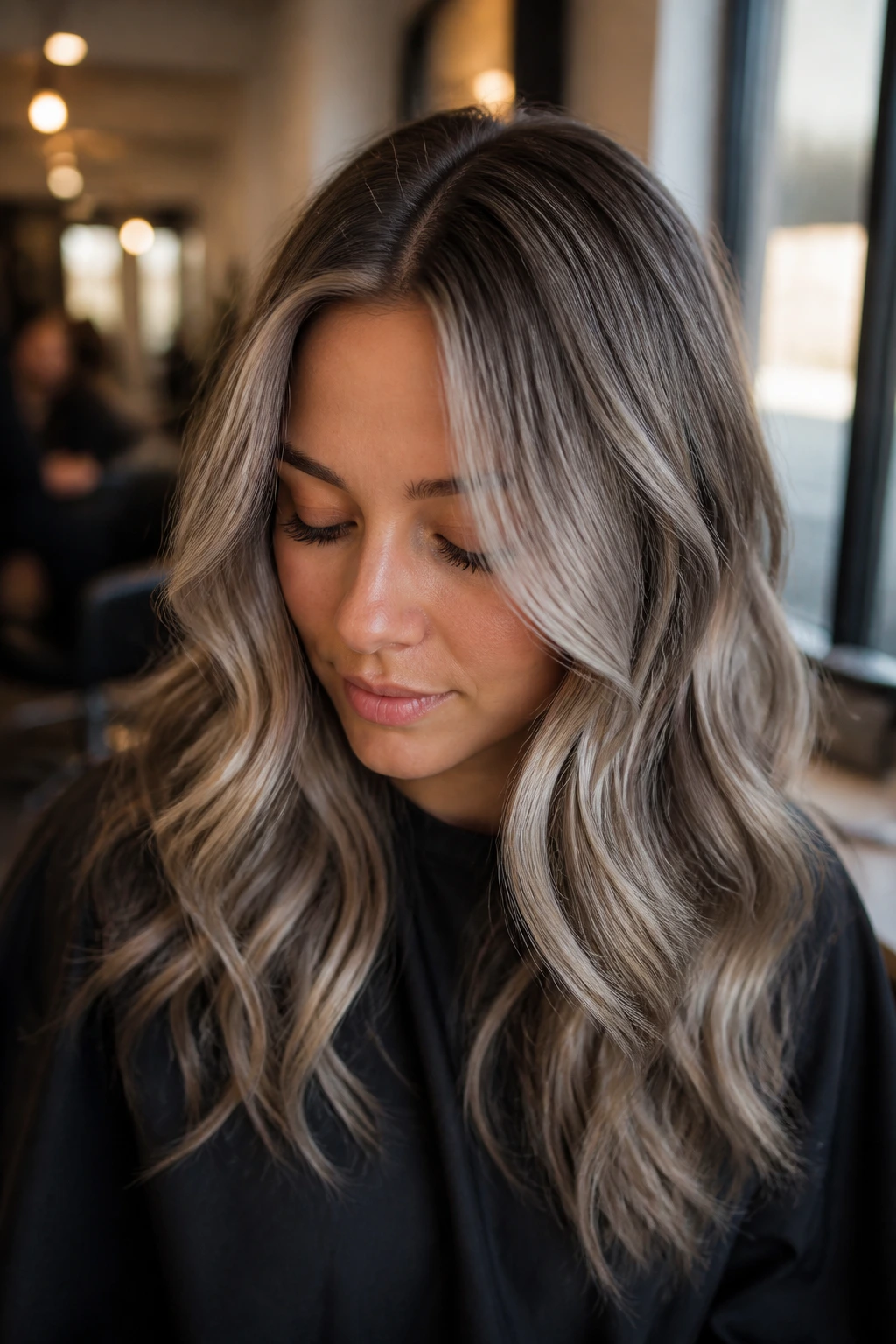 Close-up of ash-toned hair with subtle root shadow