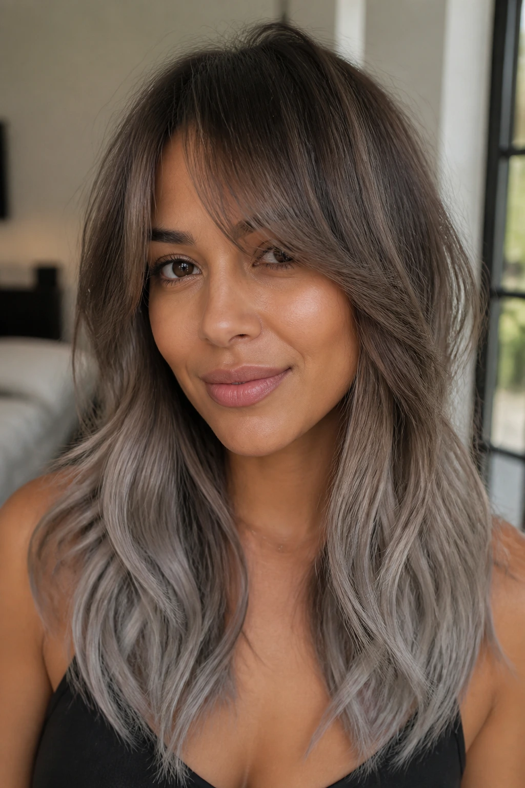 Close-up portrait of a real woman with ash brown to gray ombre hair
