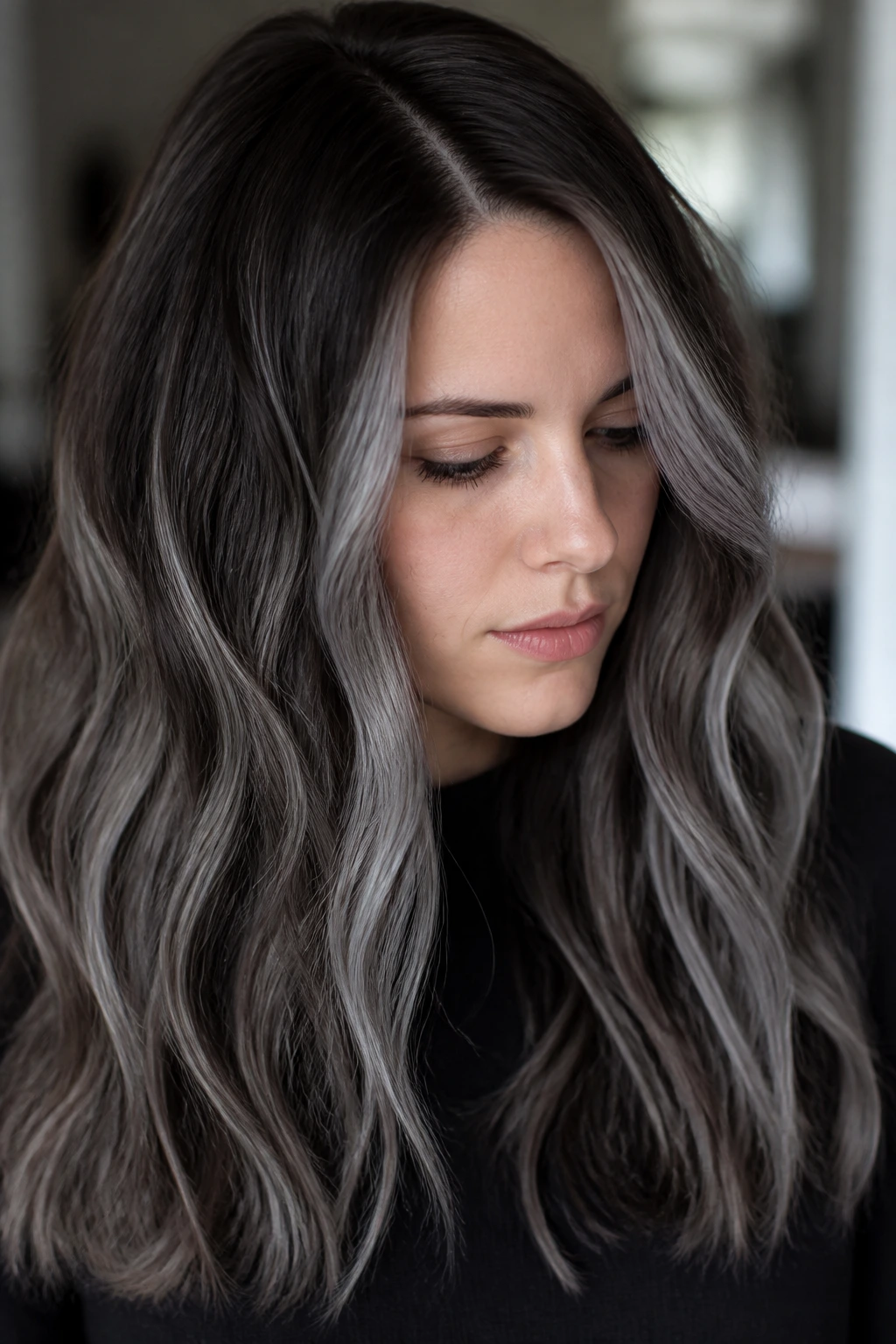 Close-up portrait of a person with ash root shadow and grey ribbons
