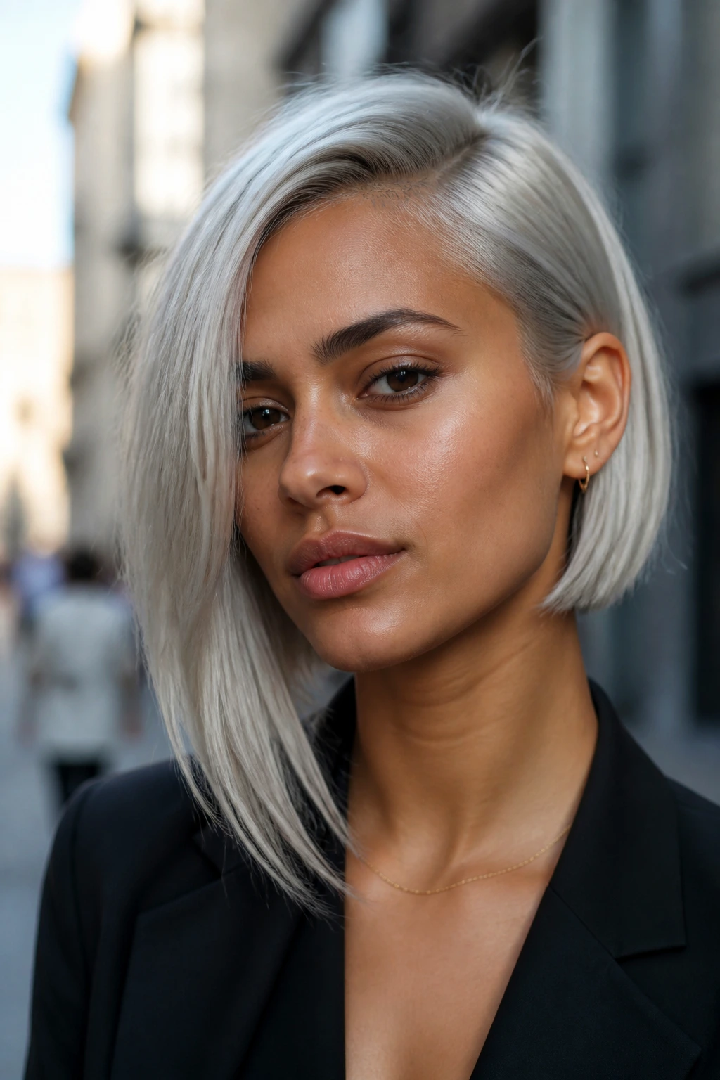 Close-up portrait of a real person with asymmetrical platinum bob on olive skin