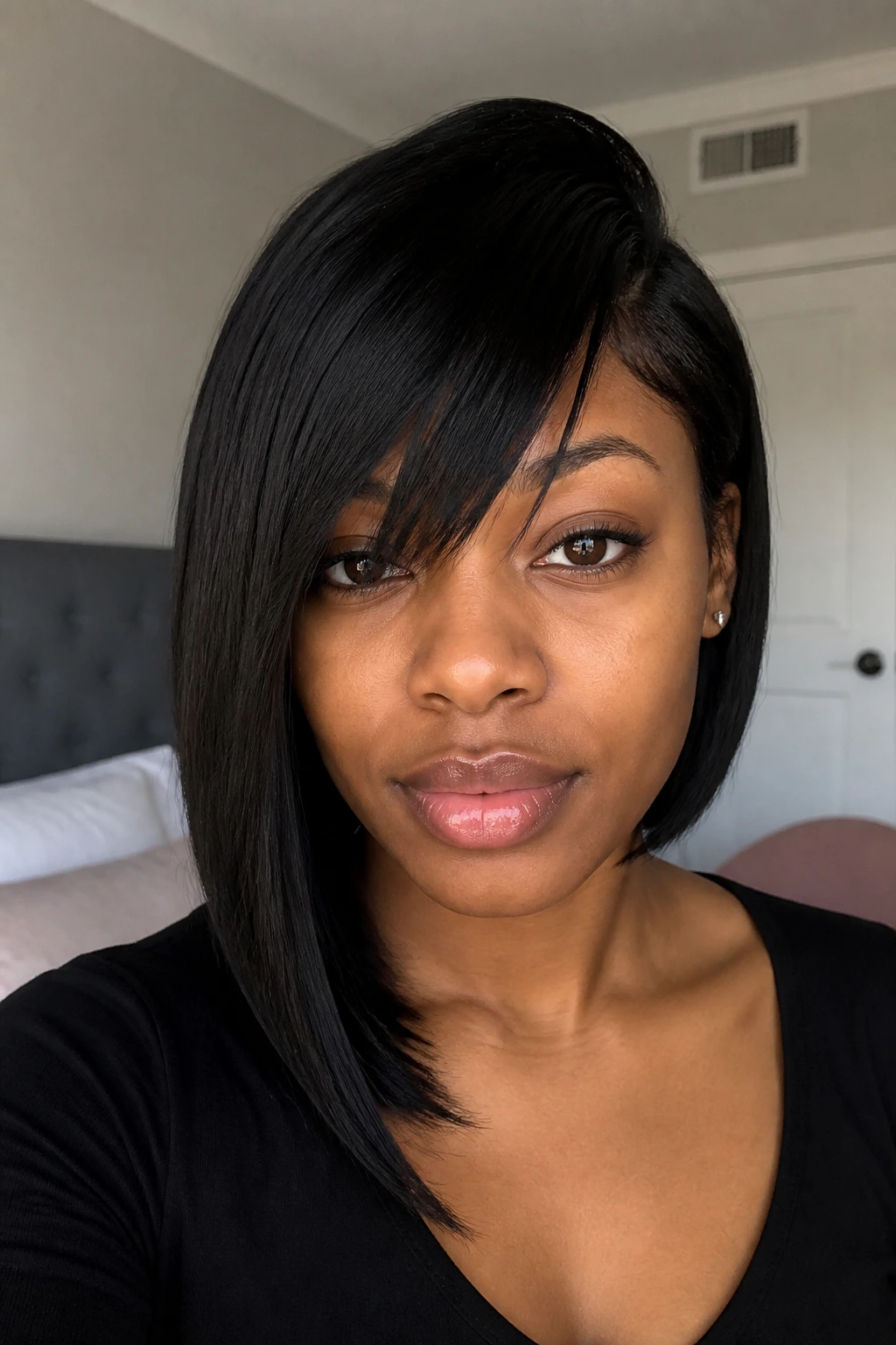 Close-up portrait of a real woman with asymmetrical lob and diagonal bangs in natural window light