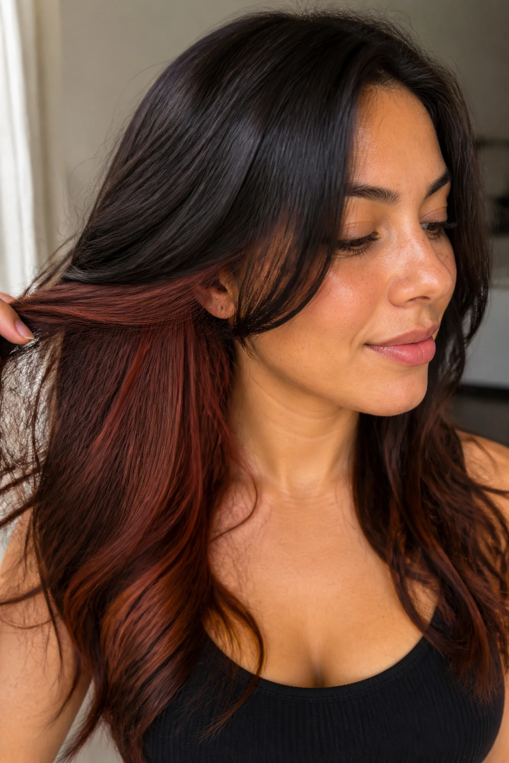 Close-up portrait showing hidden auburn peekaboo panels under the hair