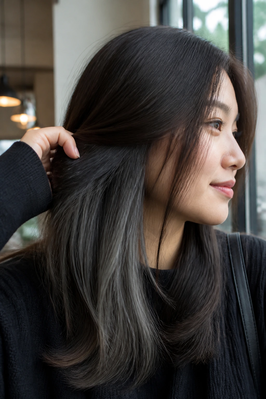 Close-up of a woman showing graphite peekaboo layers under the top hair