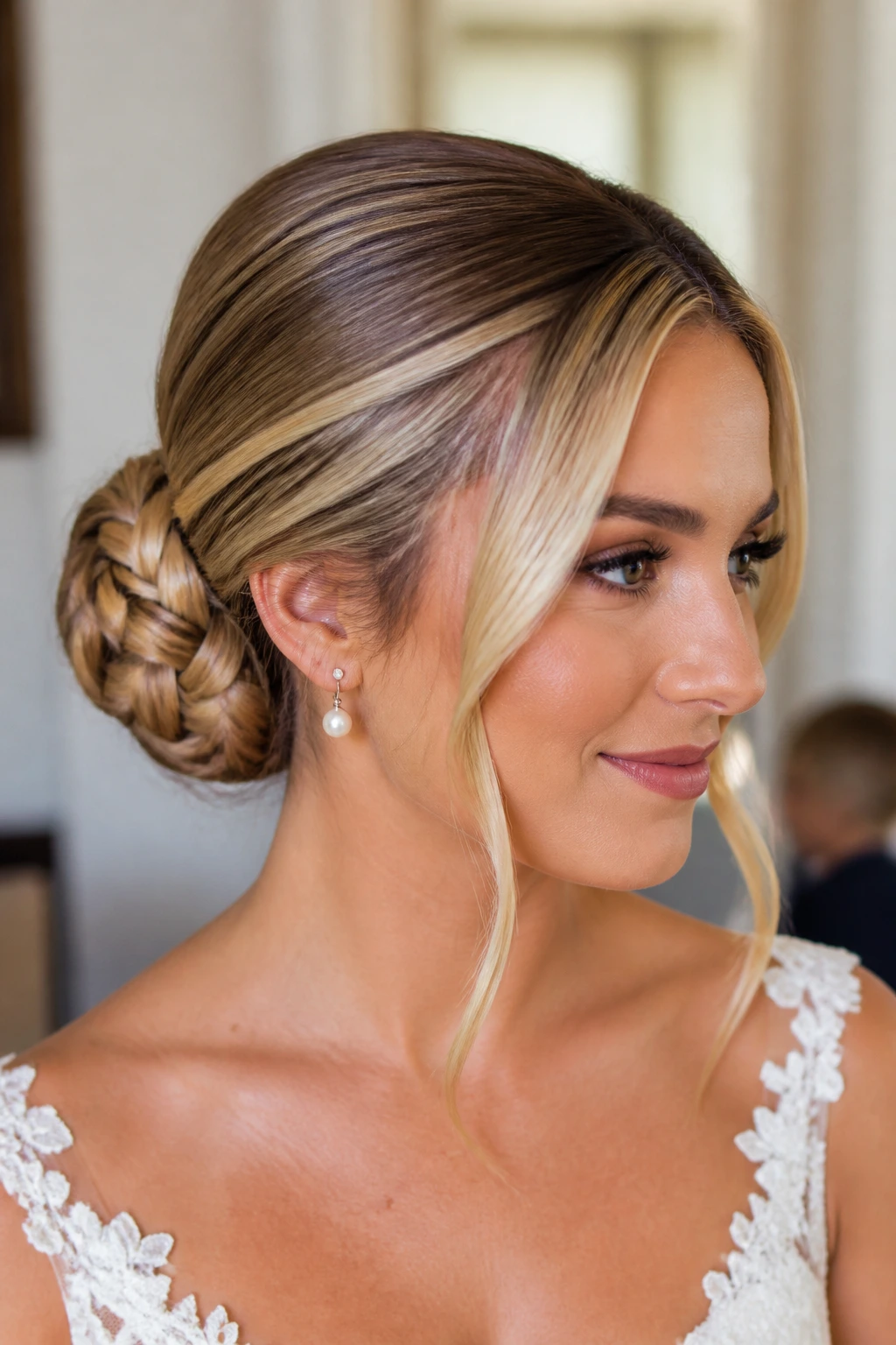 Close-up of a real bride with a basket-weave low bun and sleek sides