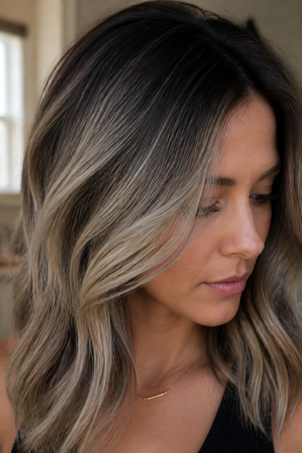 Portrait showing beige-ash babylights with smoky root melt.
