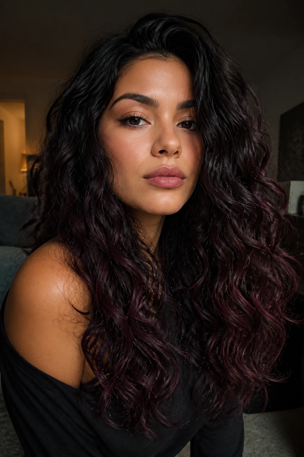 Close-up of blackberry brunette ombre with berry-toned ends on long curls.