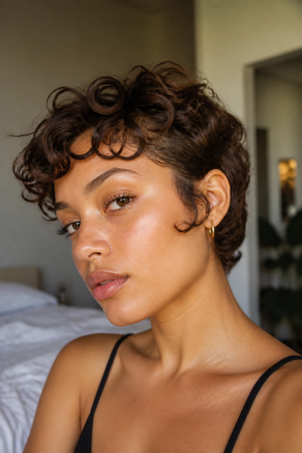 Close-up portrait of a real woman with bixie cut and playful sideburns in natural light