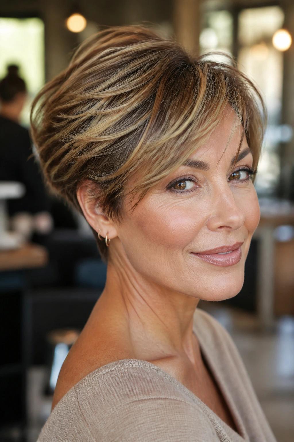 Close-up portrait of a real woman with a sculpted bixie and golden babylights fringe