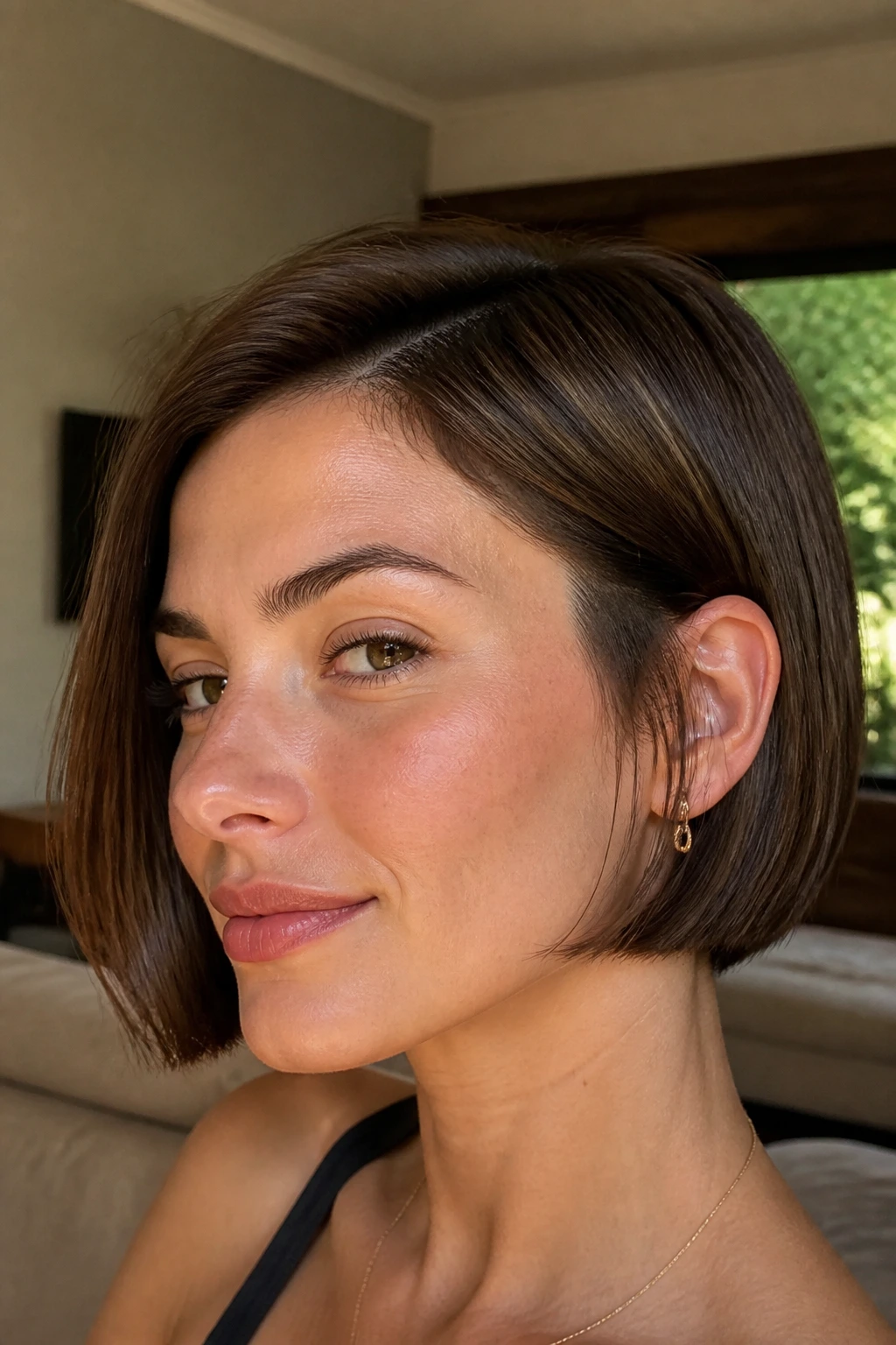 Close-up portrait of a real person with a blunt-edged bob and lifted crown for a defined shape