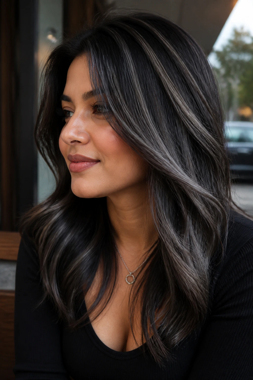 Dark brunette with bold ash-black stripes at crown and mid-lengths.