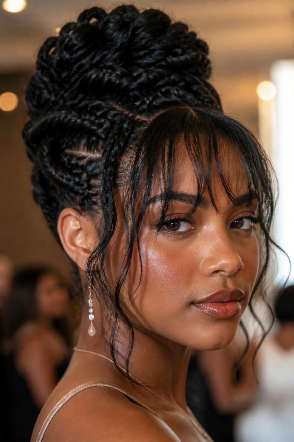 Close up of a real Black woman with braided updo and face-skimming fringe