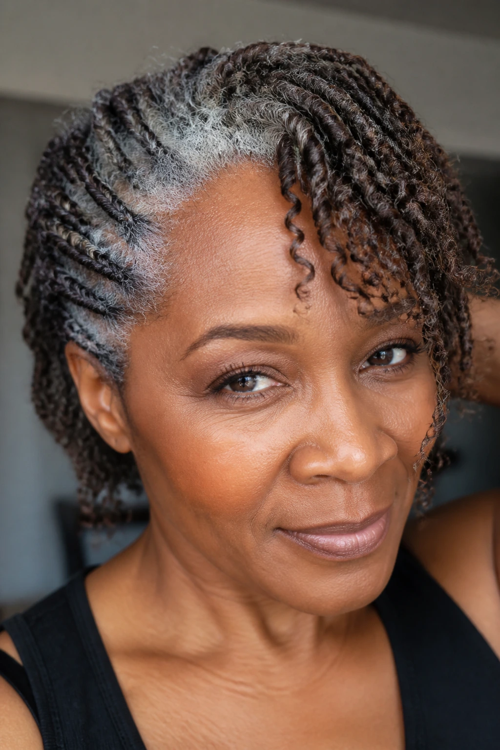 Real person with braids/twist-out texture blending gray and brown hair in natural light
