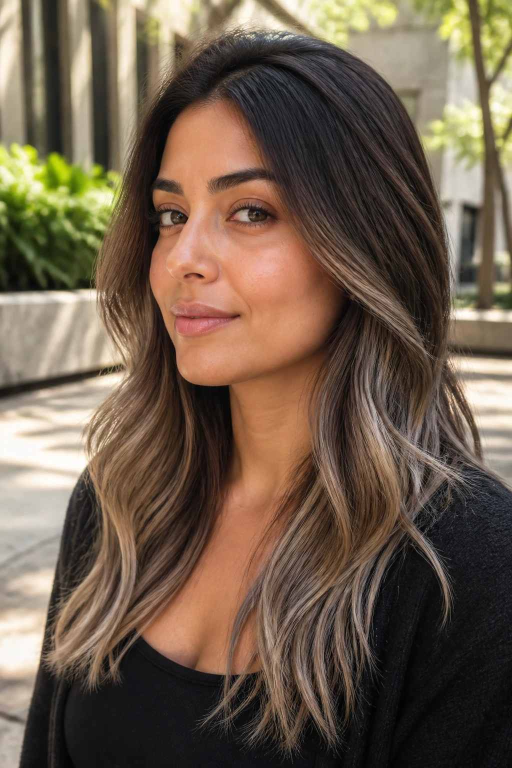 Close-up portrait of a real woman with a brunette base and cool ash ends