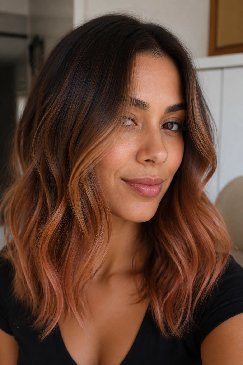 Close-up of olive-skinned woman with bronze strawberry balayage