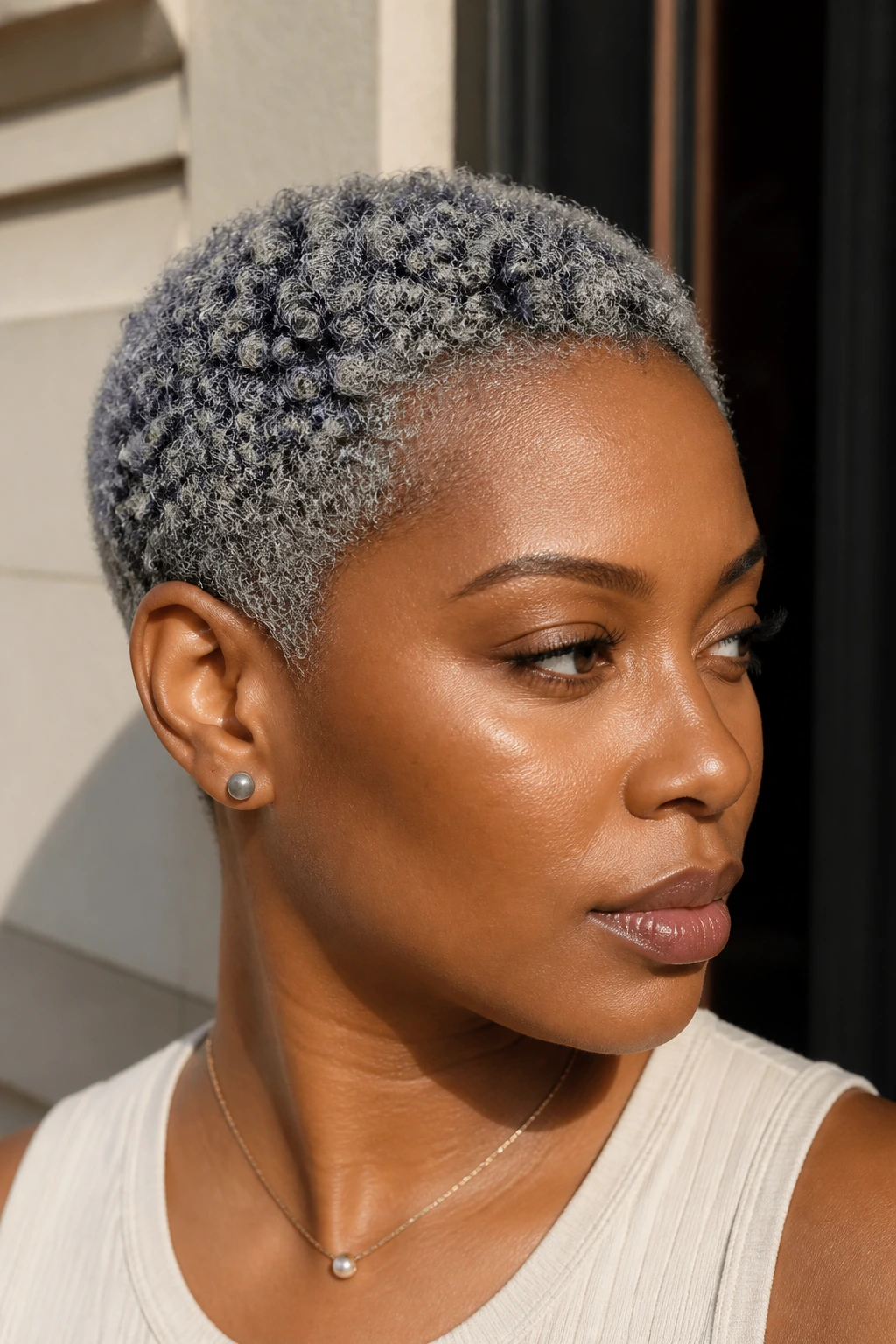 Close-up of real person with brushed titanium TWA and crown depth.