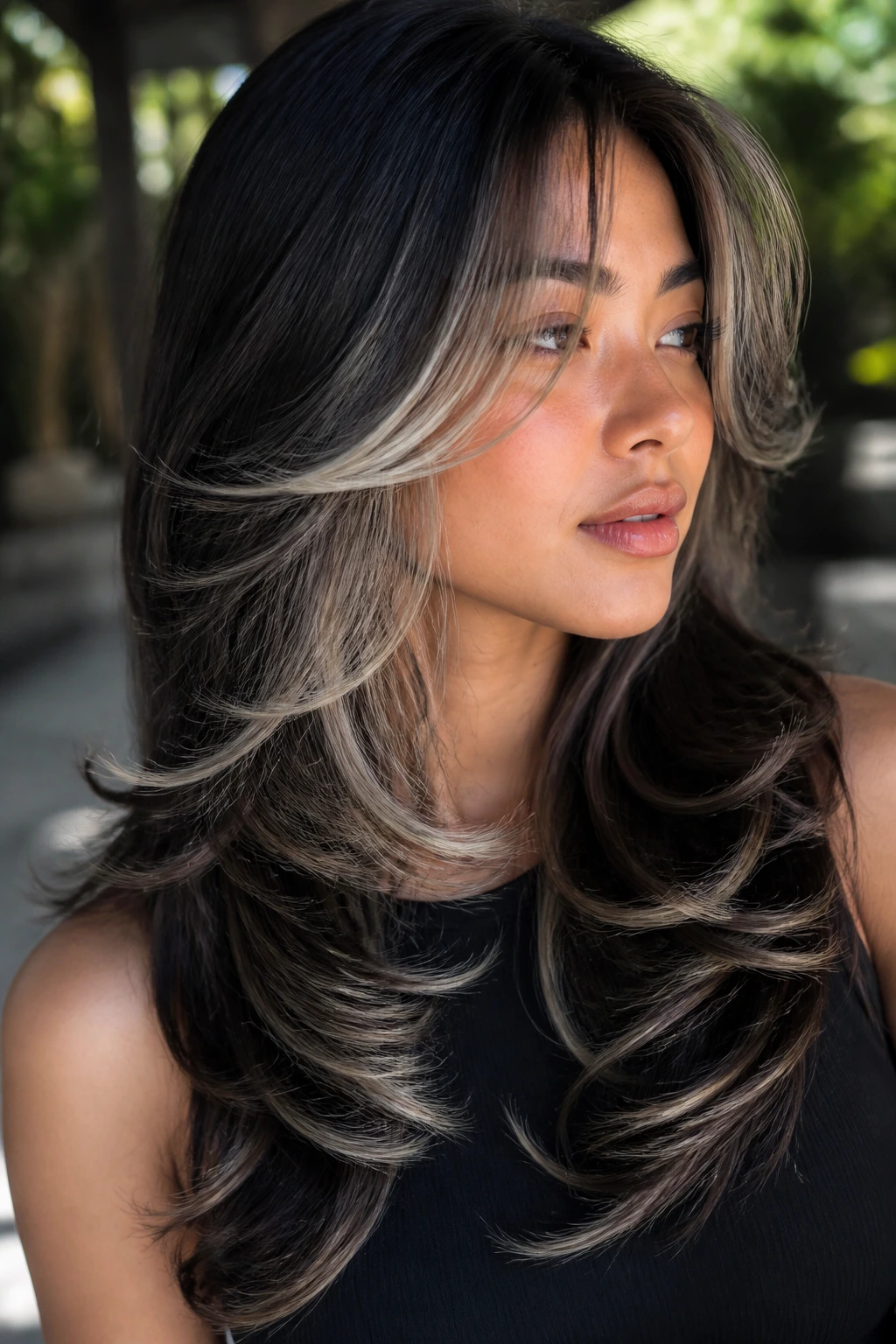 Portrait of a real woman with frost butterfly layers on long dark hair