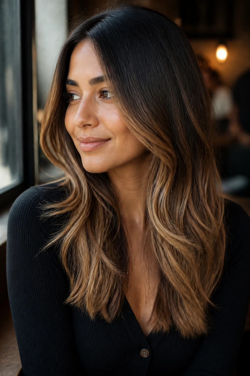 Portrait showing caramel balayage through mid-lengths on a heart-shaped face.
