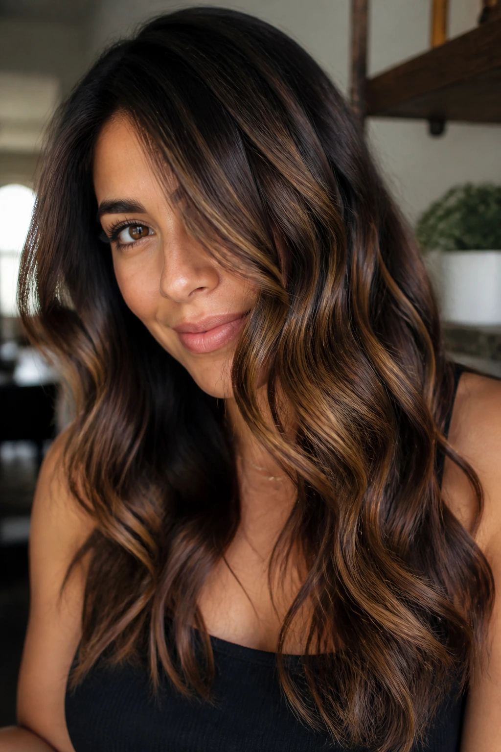 Brunette with caramel highlights styled in loose waves