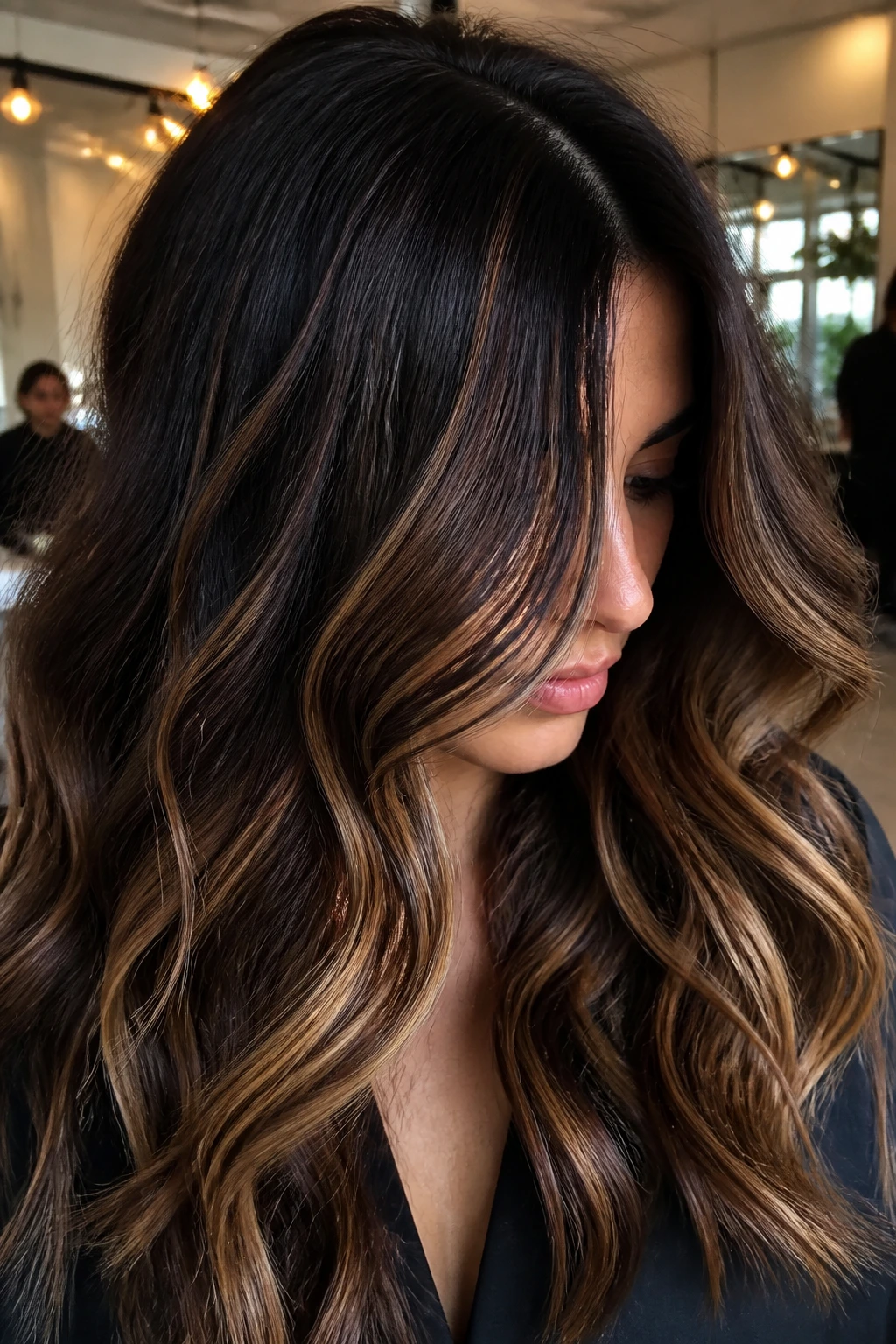 Close-up of dark hair with soft caramel ribbons through mid-lengths and around the face