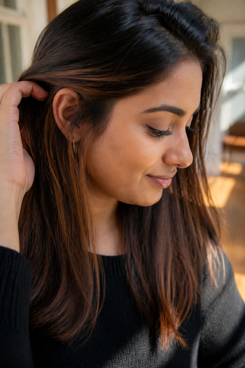 Close-up of chestnut peekaboo panels revealed behind the hair