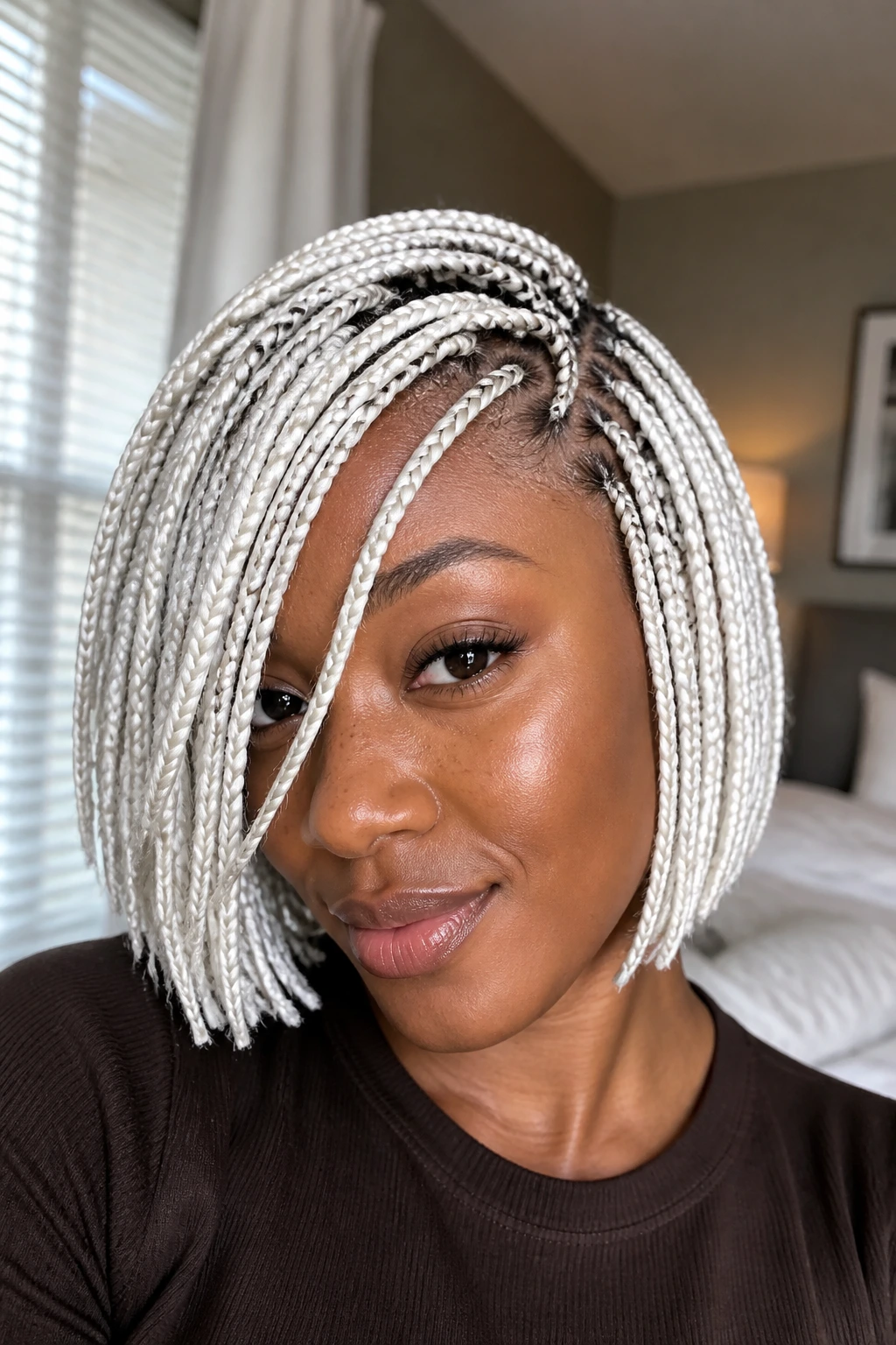 Close-up of a real person with a chin-length braided bob and a draped front piece.