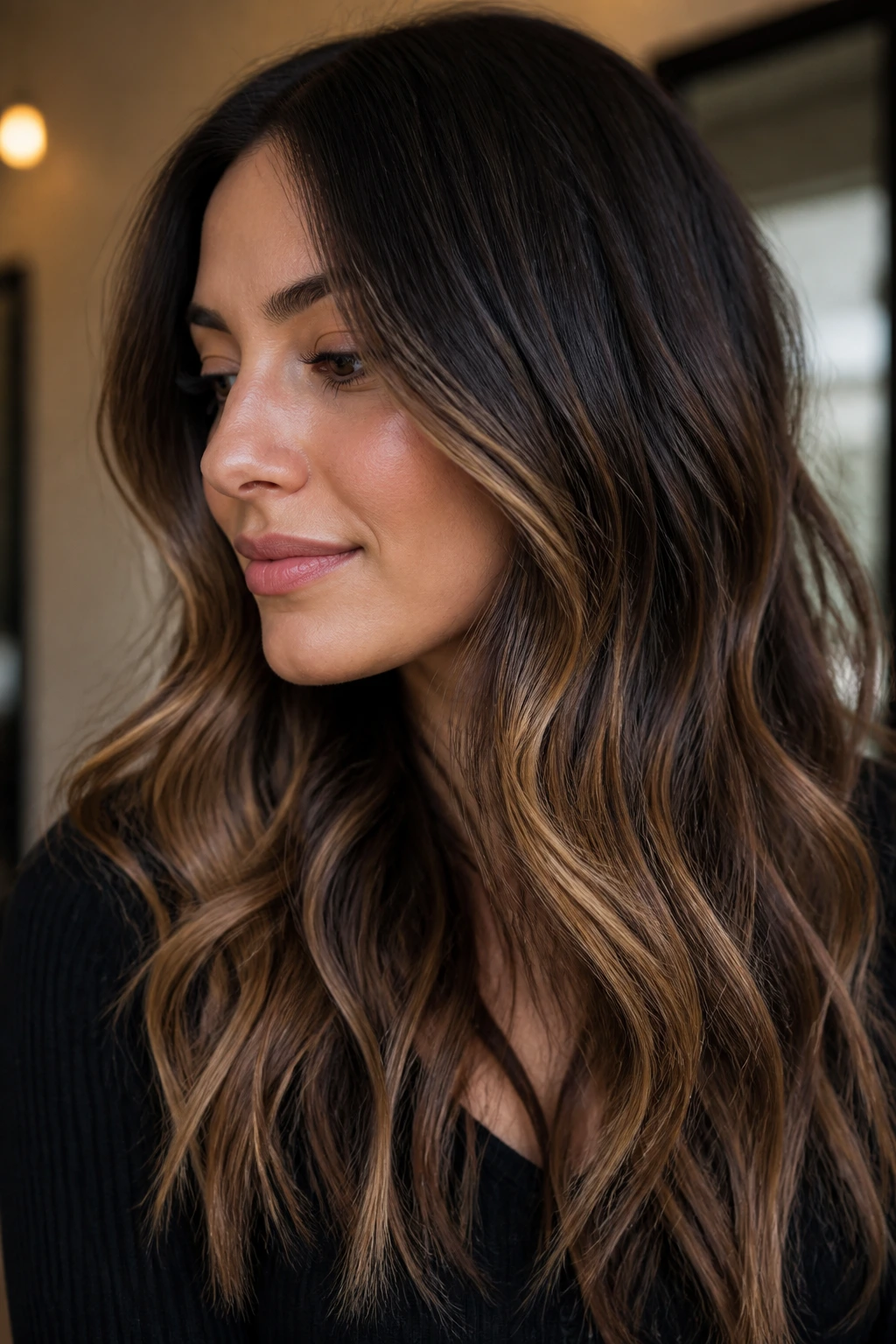 Close-up of a real brunette with chocolate base and sandy ribbons through mid-lengths