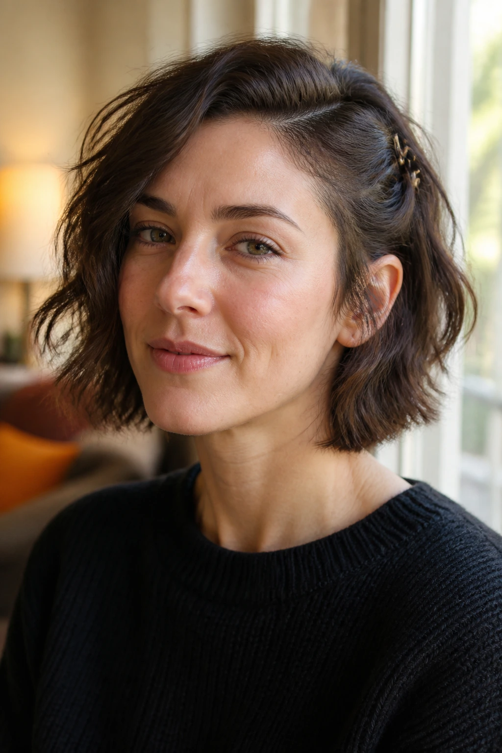 Close-up portrait of a real woman with a choppy bob and pinned-back side highlighting cheekbone