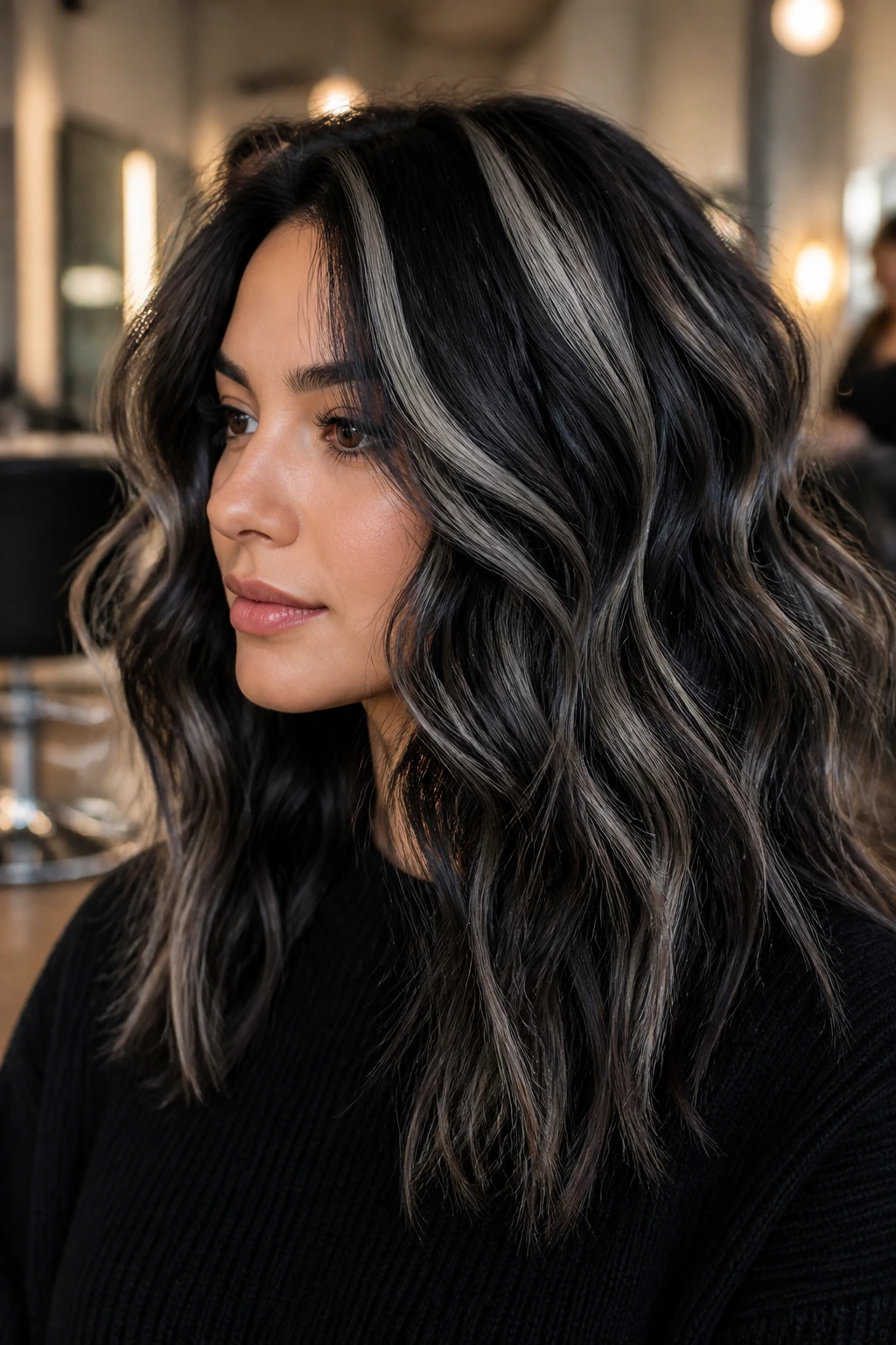 Close-up of thick hair with chunky midnight foils creating bold contrast