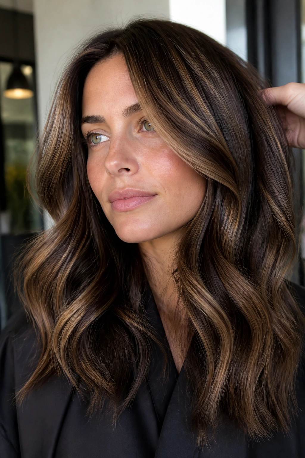 Close-up of thick brunette hair with chunky caramel foils