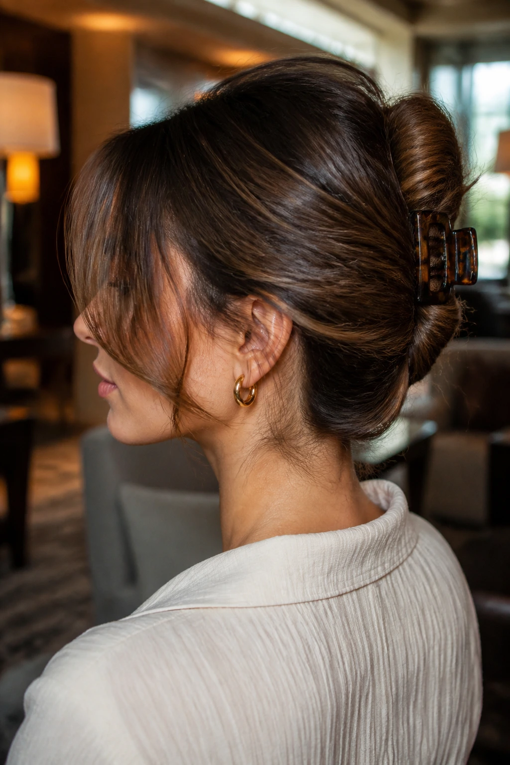 Portrait of a woman with a claw-clip French twist.