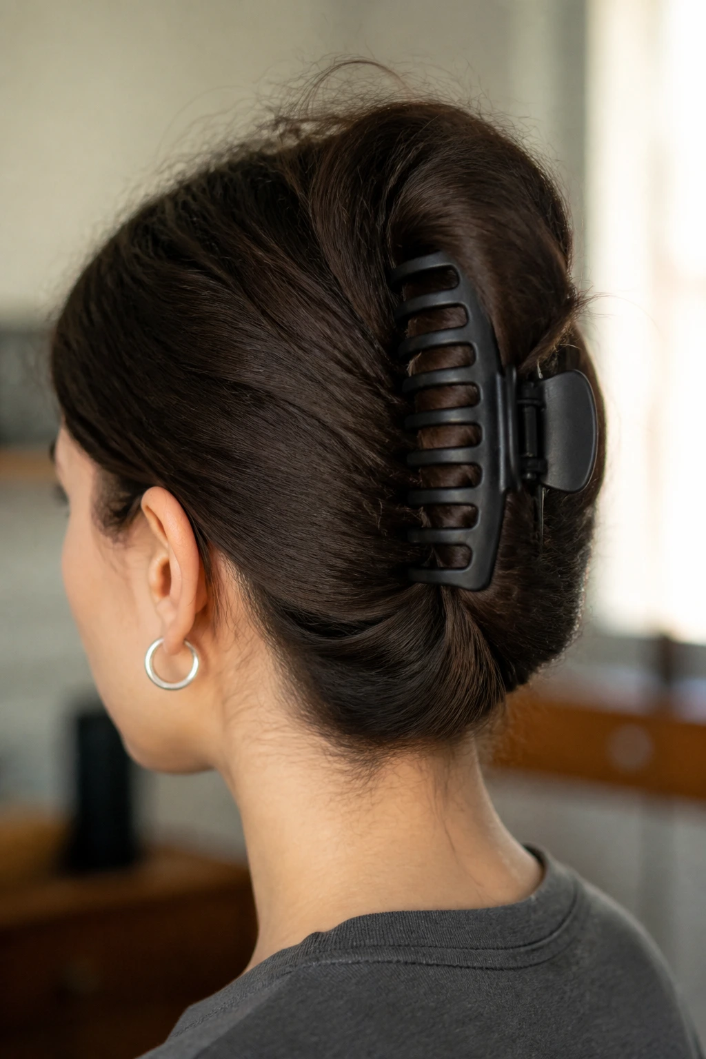 Close-up portrait of a real person with claw clip French twist on thick hair