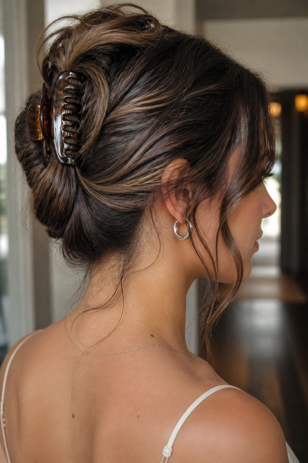 Portrait of a woman with a claw-clip French twist and brunette lowlights