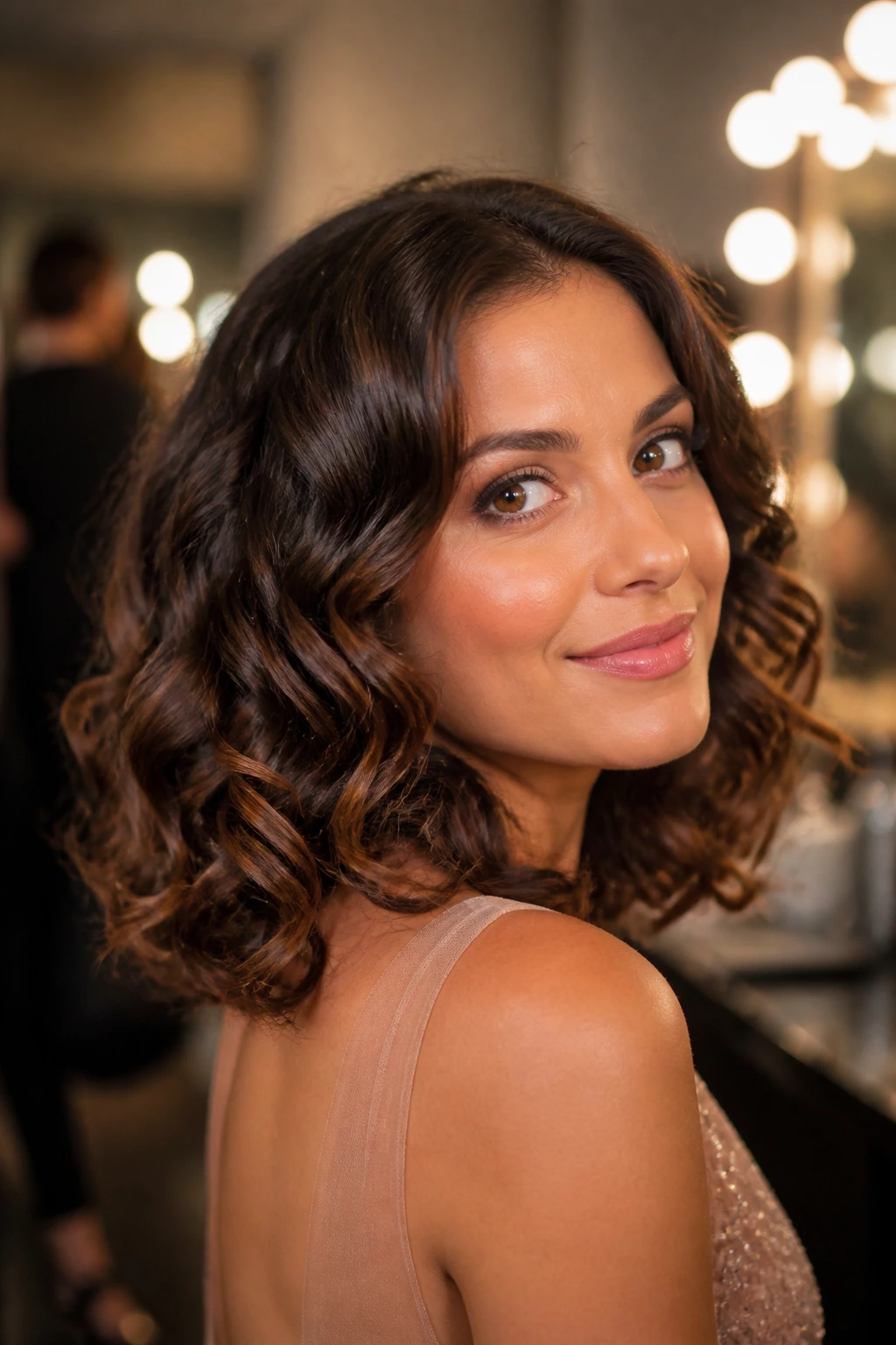 Real woman with fuller-looking shoulder-length curls from clip-in extensions.