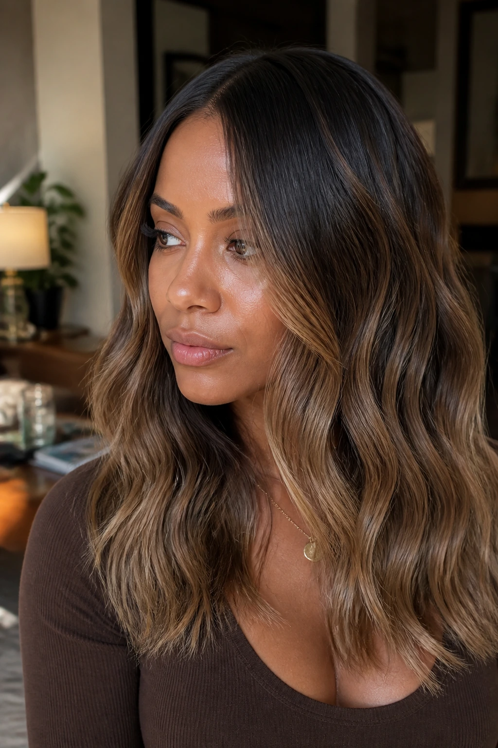 Close-up portrait of a real person with cocoa beige melt balayage and seamless grow-out.