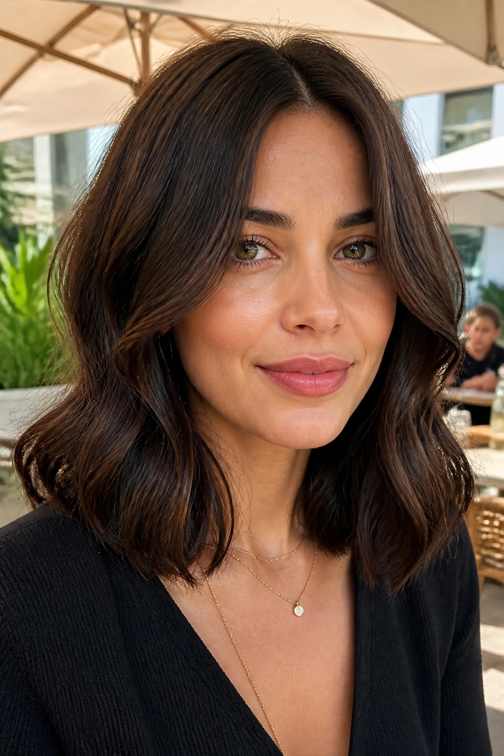 Real person with center-part cocoa lob and cheekbone bend
