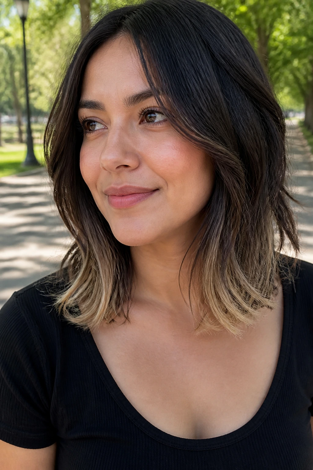 Real woman with collarbone-length hair showing bright bottom layers.