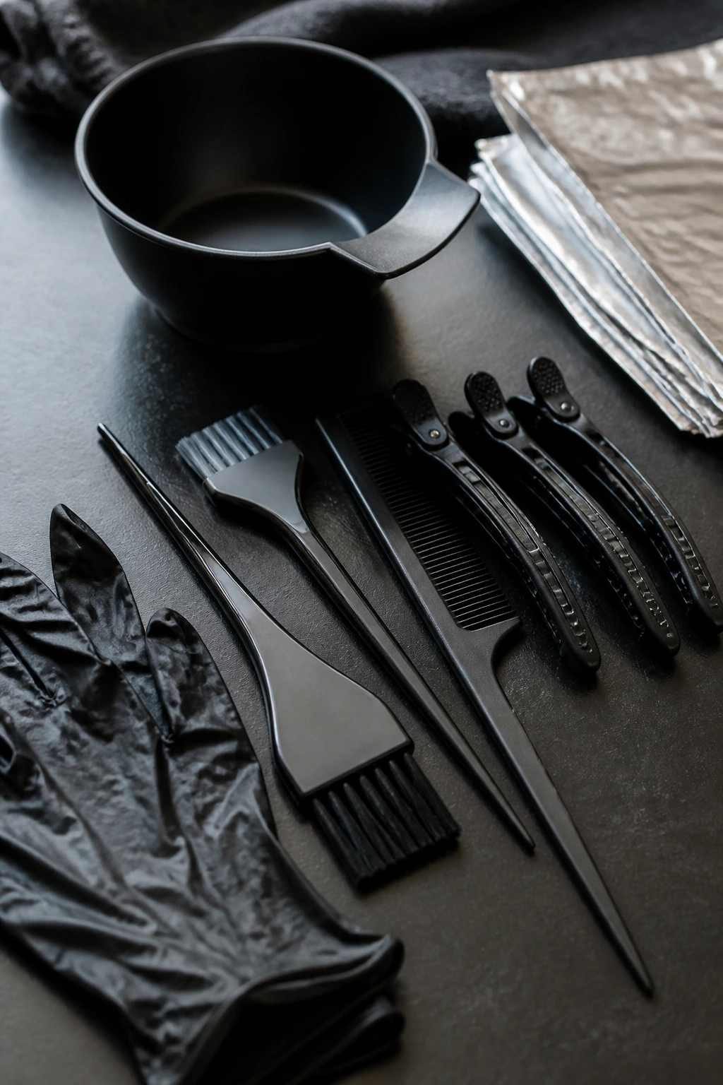 Close-up of essential grey color tools arranged on a dark surface