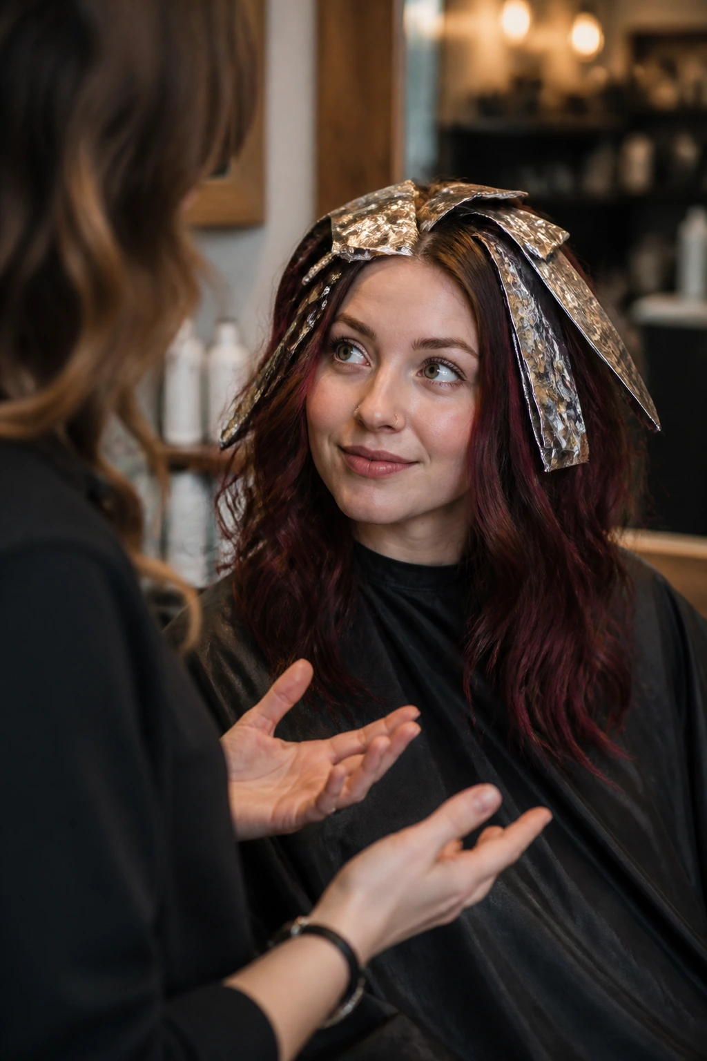 Client discussing foil placement with colorist in a salon